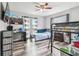 Bedroom with ceiling fan, wood-look floors, bunk beds, a desk, and a window at 8225 Medford Dr, Port Richey, FL 34668