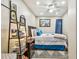 Bedroom with a ceiling fan, a picture of the beach, and an area rug at 8225 Medford Dr, Port Richey, FL 34668