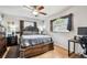 Serene bedroom with a king-sized bed, wood flooring, and ample natural light from the large windows at 8225 Medford Dr, Port Richey, FL 34668