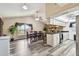 Open dining area featuring a large table, high ceilings, and a modern kitchen with stone accents at 8225 Medford Dr, Port Richey, FL 34668