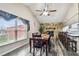 Inviting dining area with a wood table, fireplace with stone surround, and plenty of natural light at 8225 Medford Dr, Port Richey, FL 34668
