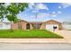 Charming single-story home featuring a lush lawn, attached garage, and inviting curb appeal with an American flag at 8225 Medford Dr, Port Richey, FL 34668