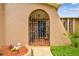 Inviting front entrance with a decorative metal gate leading to a tiled porch area of this lovely home at 8225 Medford Dr, Port Richey, FL 34668