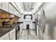 Well-equipped kitchen featuring stainless steel appliances, granite countertops, and ample cabinet space at 8225 Medford Dr, Port Richey, FL 34668
