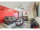 Spacious living room with comfortable leather sofas, stylish decor, and a mounted TV for entertaining at 8225 Medford Dr, Port Richey, FL 34668