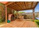 Outdoor patio features a brick fireplace and a wood swing at 8225 Medford Dr, Port Richey, FL 34668