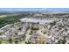 Panoramic aerial view showcasing the neighborhood's homes and scenic lake, surrounded by lush trees at 8407 Hunters Fork Loop, Ruskin, FL 33573