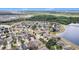 An aerial perspective highlights the community's well-maintained homes alongside a beautiful lake at 8407 Hunters Fork Loop, Ruskin, FL 33573