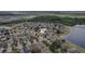 Aerial view of the neighborhood with a lake nearby, showcasing an attractive community layout at 8407 Hunters Fork Loop, Ruskin, FL 33573