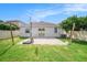 Backyard features a basketball hoop, grass, paver patio, and white fence at 8407 Hunters Fork Loop, Ruskin, FL 33573