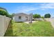 Backyard features basketball hoop, paver patio, grassy area, and fencing at 8407 Hunters Fork Loop, Ruskin, FL 33573