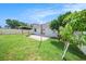 Backyard with a basketball hoop and paver patio with green grass at 8407 Hunters Fork Loop, Ruskin, FL 33573