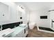 Bathroom features dual sinks, a soaking tub, and a walk-in shower at 8407 Hunters Fork Loop, Ruskin, FL 33573