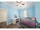 This bedroom offers wood floors, a ceiling fan, and a makeup vanity at 8407 Hunters Fork Loop, Ruskin, FL 33573