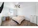 This bedroom offers wood floors, a ceiling fan, and a large window for natural light at 8407 Hunters Fork Loop, Ruskin, FL 33573