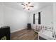 Bright bedroom features wood floors, neutral walls, ceiling fan, and a window at 8407 Hunters Fork Loop, Ruskin, FL 33573
