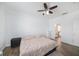 Bedroom features wood floors, a ceiling fan, and access to the bathroom at 8407 Hunters Fork Loop, Ruskin, FL 33573