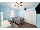 This bedroom offers wood floors, a ceiling fan, and a large closet at 8407 Hunters Fork Loop, Ruskin, FL 33573