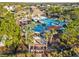 Aerial view of the community pool, clubhouse, and surrounding palm trees at 8407 Hunters Fork Loop, Ruskin, FL 33573