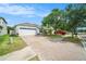 Charming single-story home featuring a brick driveway, two-car garage, and well-kept landscaping at 8407 Hunters Fork Loop, Ruskin, FL 33573