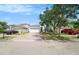 Home exterior featuring a two-car garage, brick driveway, and well-maintained landscaping at 8407 Hunters Fork Loop, Ruskin, FL 33573