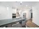 Bright kitchen featuring white cabinets, stainless steel appliances, and a spacious island with bar seating at 8407 Hunters Fork Loop, Ruskin, FL 33573