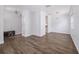Bright living room featuring hardwood floors and crown molding with views into the kitchen and arched doorway at 8407 Hunters Fork Loop, Ruskin, FL 33573