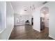 Bright living room featuring hardwood floors and crown molding with views into the kitchen and front yard at 8407 Hunters Fork Loop, Ruskin, FL 33573