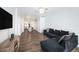Open-concept living room featuring a large sectional, TV, and flows into the kitchen with bar seating at 8407 Hunters Fork Loop, Ruskin, FL 33573