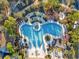 Overhead shot of the community's resort-style pool featuring unique curves, lounge seating and sunshades at 8407 Hunters Fork Loop, Ruskin, FL 33573