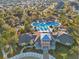 Aerial view of the community pool with blue lounge chairs and meticulously manicured landscaping at 8407 Hunters Fork Loop, Ruskin, FL 33573