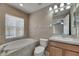 Bathroom featuring a soaking tub and a single sink vanity at 925 Windton Oak Dr, Ruskin, FL 33570