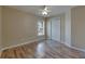 This bedroom features wood floors, a window, and closet at 925 Windton Oak Dr, Ruskin, FL 33570