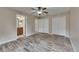 Spacious bedroom featuring wood-look floors, and a view into the adjacent bathroom at 925 Windton Oak Dr, Ruskin, FL 33570