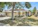 Charming single-story home with attached garage, landscaping, and manicured lawn at 925 Windton Oak Dr, Ruskin, FL 33570