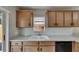 Functional kitchen with light wood cabinets, white counters, and subway tile backsplash at 925 Windton Oak Dr, Ruskin, FL 33570