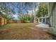 A vast backyard featuring mature trees, a wooden fence and the exterior of a single-story home at 9613 River Rd, Spring Hill, FL 34608