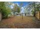 Large backyard featuring mature trees and partial fencing at 9613 River Rd, Spring Hill, FL 34608
