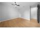 Bright bedroom featuring wood flooring and a ceiling fan at 9613 River Rd, Spring Hill, FL 34608