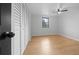 Bedroom with closet, wood-look floors, ceiling fan, and window overlooking the trees at 9613 River Rd, Spring Hill, FL 34608