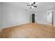 Large bedroom featuring new hardwood flooring, fresh paint and a walk-in closet at 9613 River Rd, Spring Hill, FL 34608