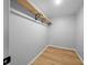 Walk-in closet with hardwood floors and a storage shelf at 9613 River Rd, Spring Hill, FL 34608