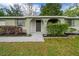 Close up front of house featuring an arched entrance with painted brick at 9613 River Rd, Spring Hill, FL 34608