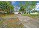 The front exterior of a charming single-story home with a well-manicured lawn and private driveway at 9613 River Rd, Spring Hill, FL 34608