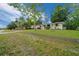 The front exterior of a charming single-story home with a well-manicured lawn and private driveway at 9613 River Rd, Spring Hill, FL 34608