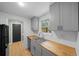 Renovated kitchen featuring stainless steel appliances and butcher block counters at 9613 River Rd, Spring Hill, FL 34608
