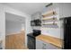 Modern kitchen featuring stainless steel appliances, butcher block countertops, and open shelving at 9613 River Rd, Spring Hill, FL 34608