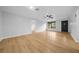 Bright living room with wood floors, ceiling fan, and natural light at 9613 River Rd, Spring Hill, FL 34608