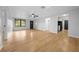 Open living room featuring wood floors and a view to the kitchen at 9613 River Rd, Spring Hill, FL 34608