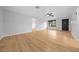 Bright, open living room with hardwood floors, fresh paint, and lots of space at 9613 River Rd, Spring Hill, FL 34608